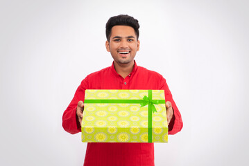 Fototapeta premium Happy Indian man giving gift box