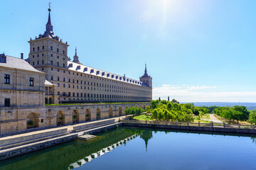 Fototapeta na wymiar Side facade of the Escorial monastery and water reservoir with gardens, copyspace.