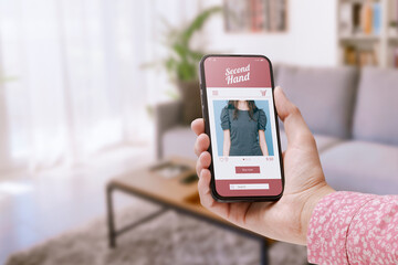 Woman using a second hand sale app on her smartphone