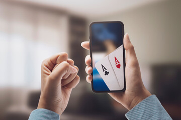 Fototapeta Woman playing poker online on her smartphone obraz