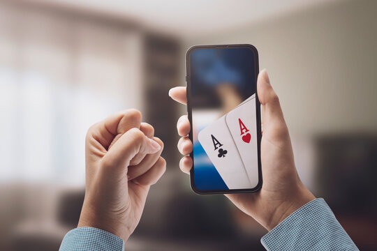 Woman playing poker online on her smartphone