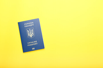 Ukrainian passport on a yellow background. top view, space for text 