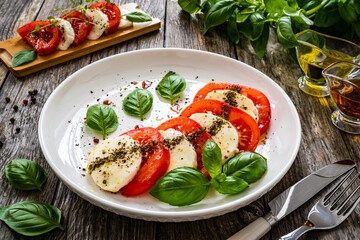 Caprese salad on wooden table
