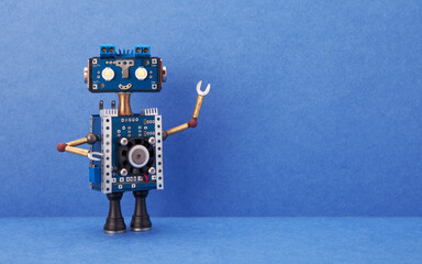 A smiling robot with a blue head and torso. A steampunk toy on blue background. Copy space for text and design.
