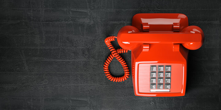Red telephone on dirty background. Top view of vintage retro push button telephone
