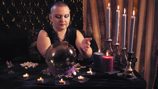 a bald sorceress woman is engaged in esoteric and divination in a magical salon