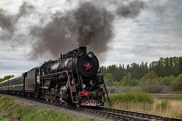 An old steam locomotive Ruskeala Express arriving at Sortavala station. Historical train in Karelia.
