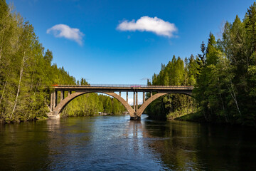 An ancient arched railway bridge over the Yanisjoki River. Railway bridge in Karelia.