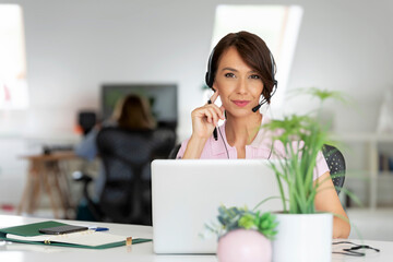 Attractive businesswoman having online meeting while working at the office