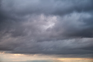 Dark rain clouds in the evening sky. Dramatic sky with an coming cloudy cyclone of bad weather