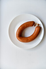 Delicious meat sausage on a white plate