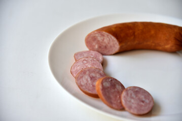 Delicious meat sausage on a white plate