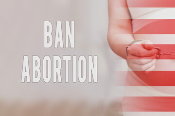 Text about the ban on abortions and chained hands of a pregnant woman, home living room