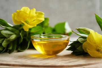 Evening primrose oil with fresh evening primrose flowers