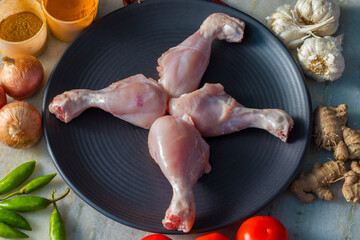raw chicken leg pieces with spices,ready to cook. 