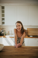 Woman is laughing in the kitchen
