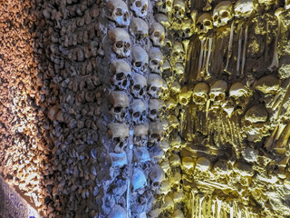Evora, Portugal - August 03 2019: Bones Chapel in Evora. Pile of skulls in a wall.