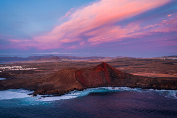 aerial view of volcano at coast during colorful sunset 