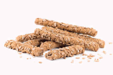Pile of integrated sticks made with whole wheat flour and sunflower seeds. Close up view.