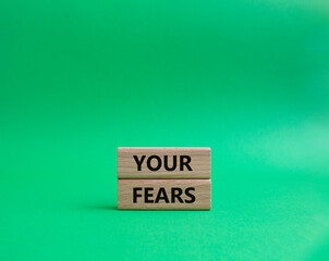 Your fears symbol. Wooden blocks with words Your fears. Beautiful green background. Business and Your fears concept. Copy space.