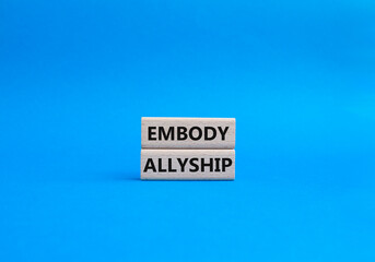 Embody Allyship symbol. Concept word Embody Allyship on wooden blocks. Beautiful blue background. Business and Embody Allyship concept. Copy space