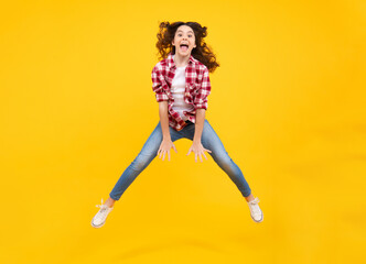 Fototapeta na wymiar Amazed teenager. Happiness, activity and child. Teenager girl jumping on isolated background. Full length, energetic little girl jumping in air, child flying up, crazy and overjoyed. Excited teen girl