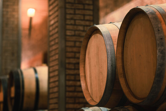 Stacked wooden barrels in a wine cellar, production and aging red wine in the traditional way