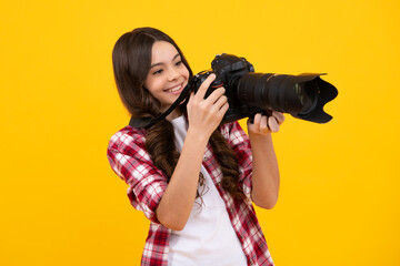 Teenager girl photographer with a dslr camera. Kid use digital camera. Child photographing. School of photography. Kid photographer beginner. Happy teenager, positive and smiling emotions