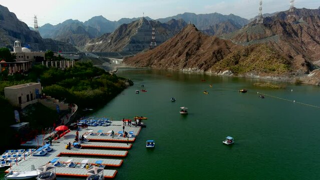 Aerial view over al rafisah dam with boats, 2022
Drone view from rafisah dam in United Arab Emirates, 2022 
