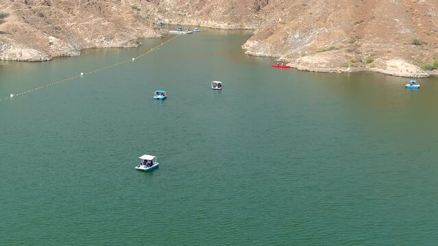 Tourist's small boats in the al rafisah dam, 2022
Drone view from rafisah dam in United Arab Emirates, 2022 
