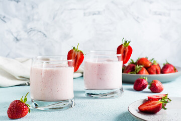 Milk smoothie with strawberries and mint in glasses on the table. Healthy homemade food