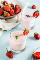 Healthy smoothie with strawberries and mint in glasses on the table. Homemade dessert. Vertical view