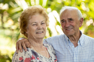 portrait of happy grandparents or senior couple smiling