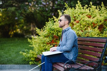 Blinded man reading by touching braille book