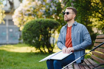 Blinded man reading by touching braille book