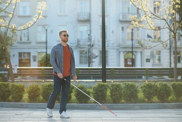 Blind man. People with disability, handicapped person and everyday life. Visually impaired man with walking stick.