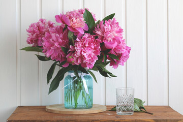 pink peonies in a glass vase, cottage still life.