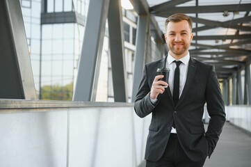 Takeaway coffee. Walk and enjoy fresh hot coffee. Waiting for someone in street. Man bearded hipster drink coffee paper cup. Businessman well groomed enjoy coffee break outdoors urban background