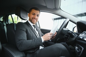 Fototapeta na wymiar Attractive elegant happy man in good car