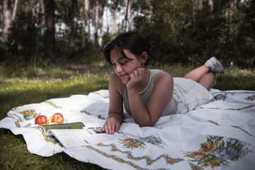 woman reading magazine in nature on a sunny day, spending time in nature self-development