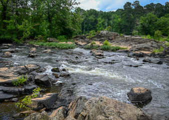 A beautiful river landscape of whitewater on the Haw River in North Carolina in summer.
