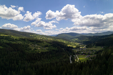 Aerial view of mountains covered with coniferous forests. Aerial View Landscape Mountain. Breathtaking aerial view of the tall mountains covered by the forest. Sunrise