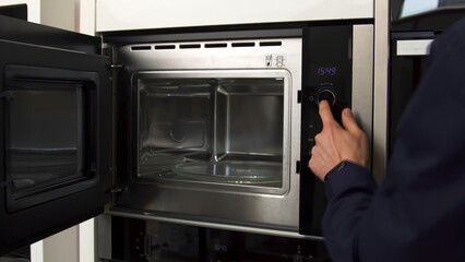 Close up of demonstrating the space inside the empty microwave oven. Household utensils. New model...