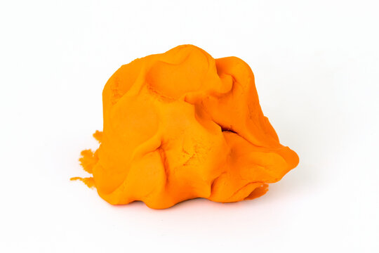 Orange colorful play dough for kids on white background. Children creativity and modeling clay