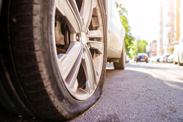 a flat car wheel. tire service. pump for car wheels. solar glare 