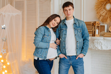 a pregnant woman and a man in denim. fashionable and comfortable clothes