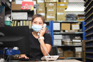 worker in warehouse,  using bar code scanner to scanning box and analyze newly arrived goods. ...