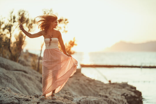 Woman Enjoying Sunset At The Beach