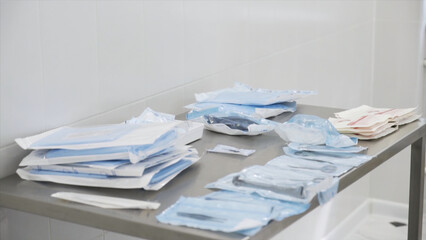 Medical laboratory details, a set of sterile disposable instruments lying on the table. Action....