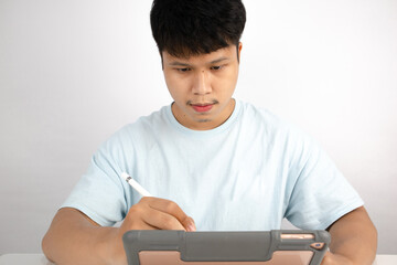 Asian man using laptop working on white background